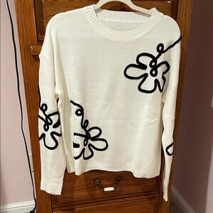 Chic White Sweater with Black Floral Design